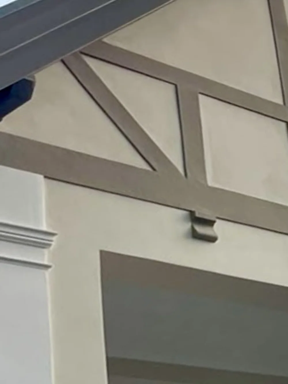 Der kleine Giebel über dem Balkon nach der Sanierung, fein verputzt mit klar herausgearbeitetem Fachwerk